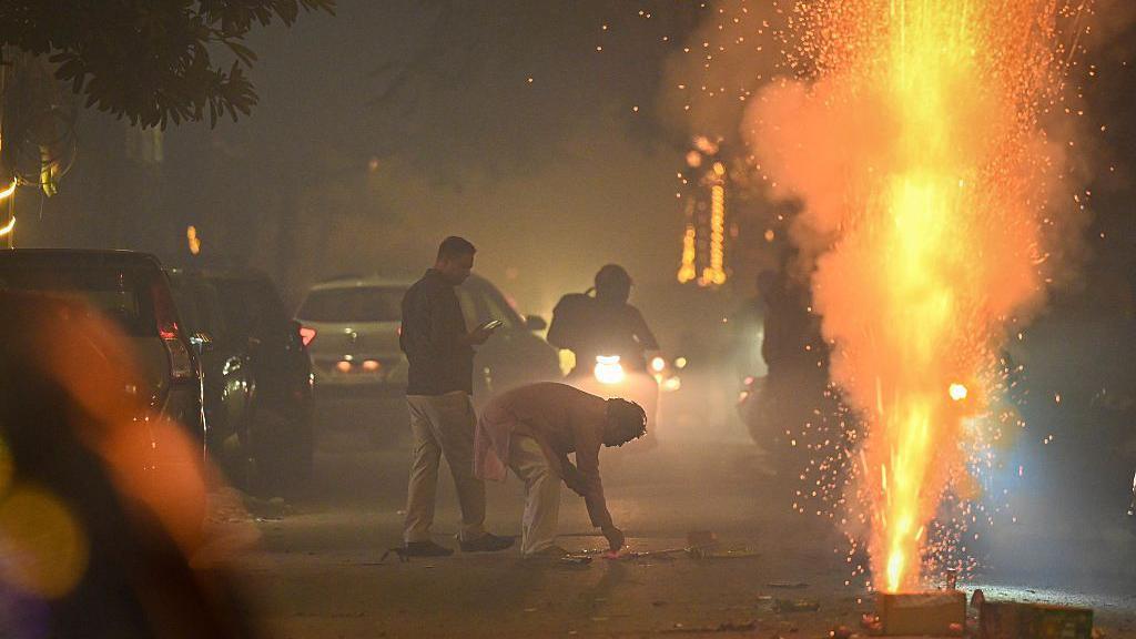 People burst crackers to celebrate Diwali Festival at Patel Nagar on October 20, 2025 in New Delhi, India.