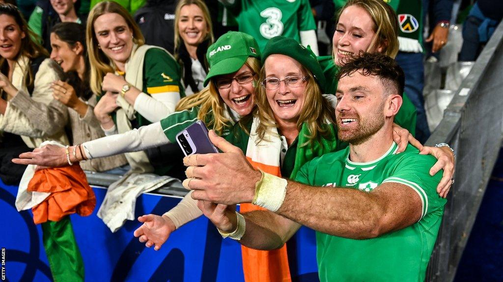 Hugo Keenan of Ireland celebrates with family members after his side's victory in the 2023 Rugby World Cup Pool B match between South Africa and Ireland at Stade de France