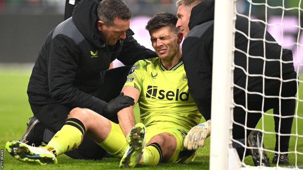 Newcastle United goalkeeper Nick Pope receives treatment for a shoulder injury