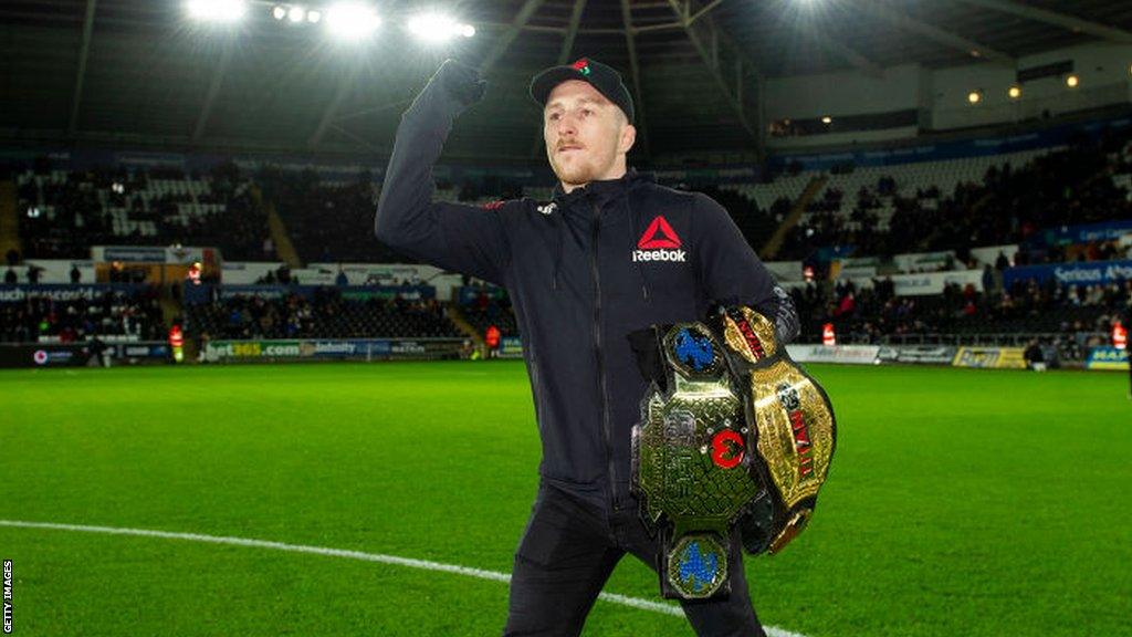 Brett Johns has always stayed close to his Swansea roots and has displayed his belts in front of fans at the city's football stadium