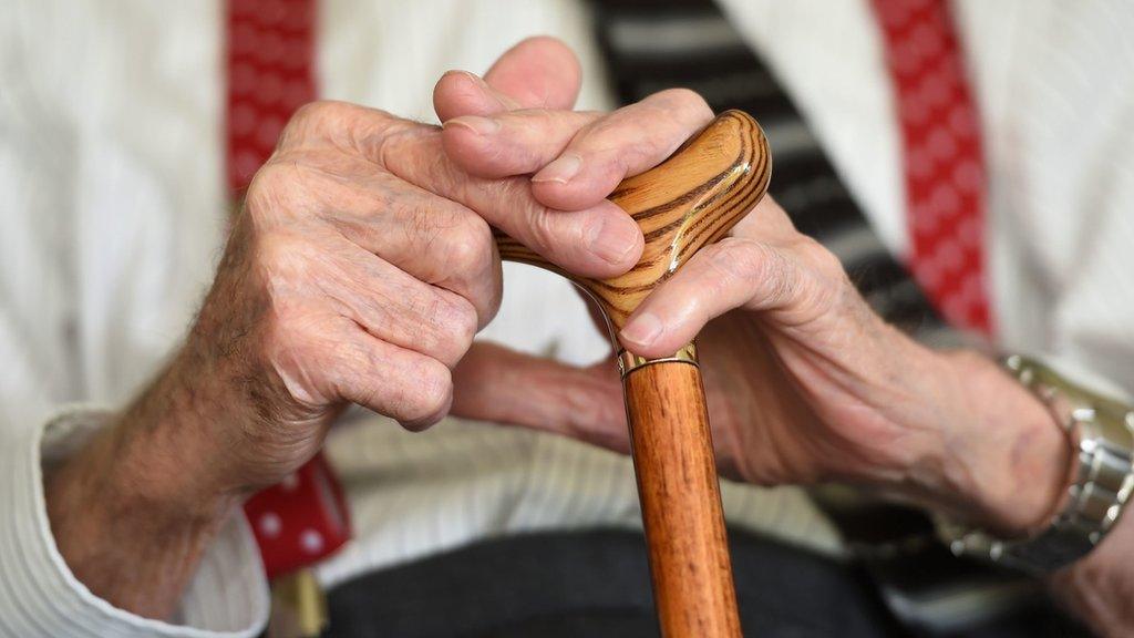 Old man holding walking stick