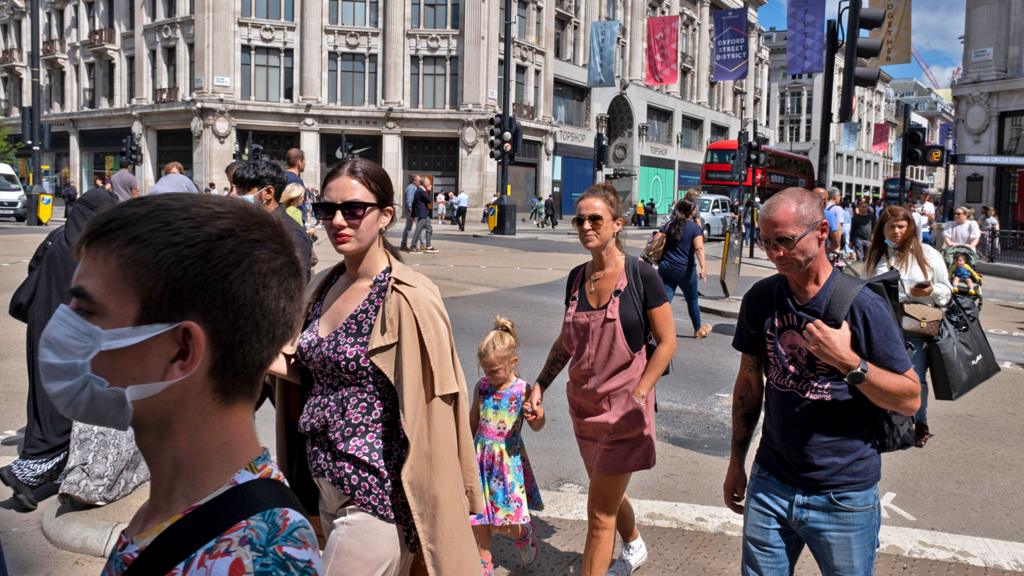 Pedestrians walk around the Oxford Street shopping district on 10 August 2021