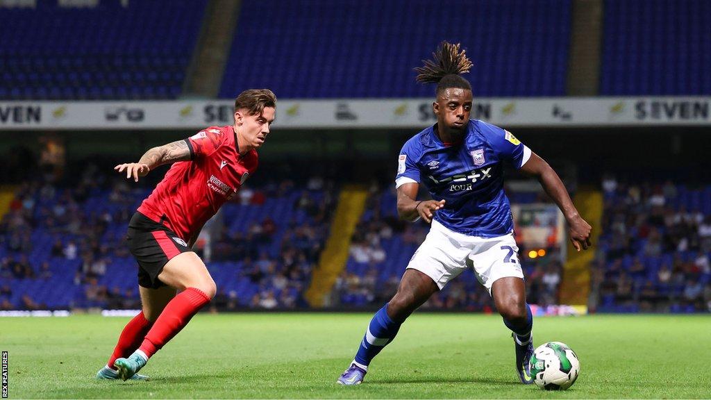 New Oxford United defender Greg Leigh in action on the pitch with Ipswich Town in the Championship.