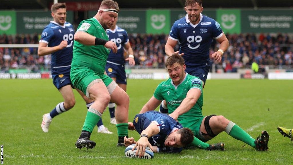 Sam James stretches to score a try against Newcastle