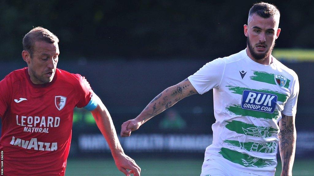 TNS' Leo Smith and Swift Hesper's Dominik Stolz compete for the ball