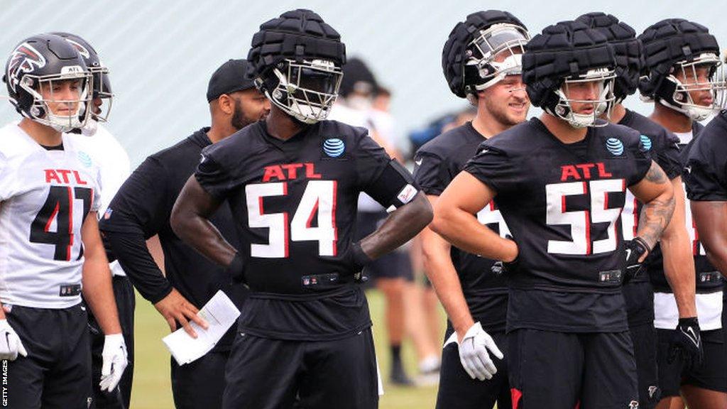 Atlanta Falcons players wearing guardian caps during practice