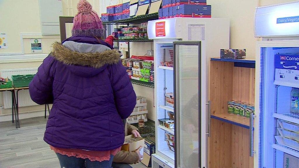 People stocking shelves with food