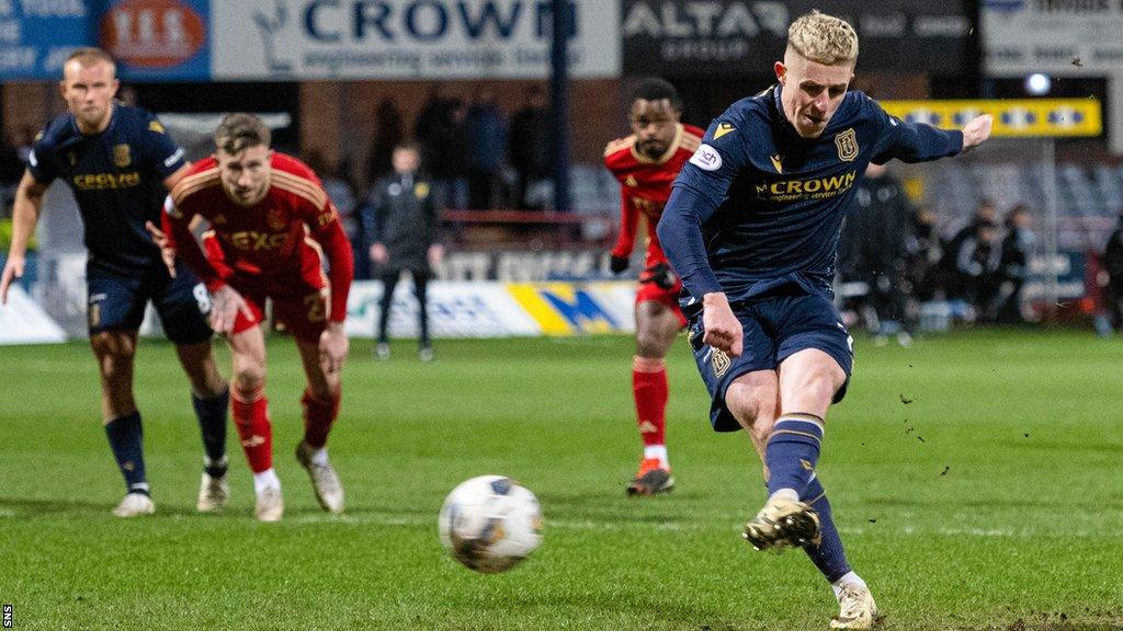 Luke McCowan scores a penalty for Dundee against Aberdeen