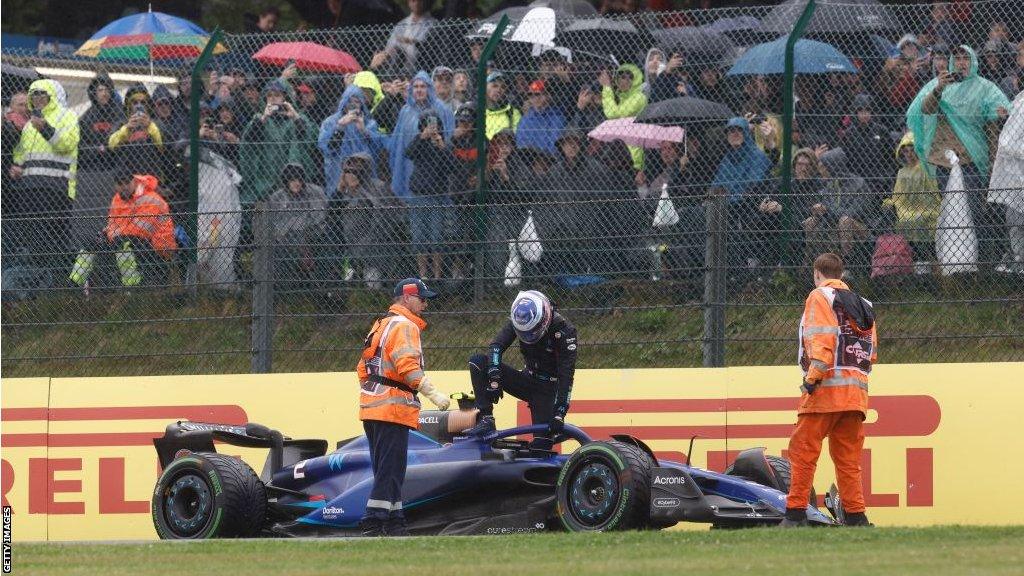 Logan Sargeant climbs from his Williams after crashing in first practice