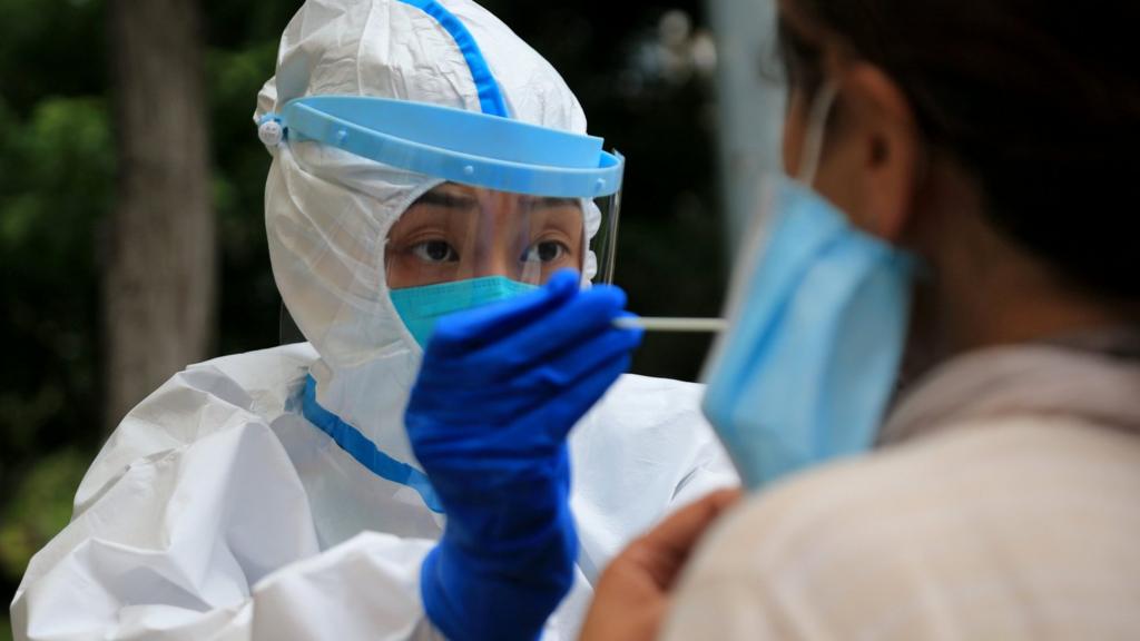 A healthcare worker carries out a Covid-19 test in Dalian, in China"s northeast Liaoning province