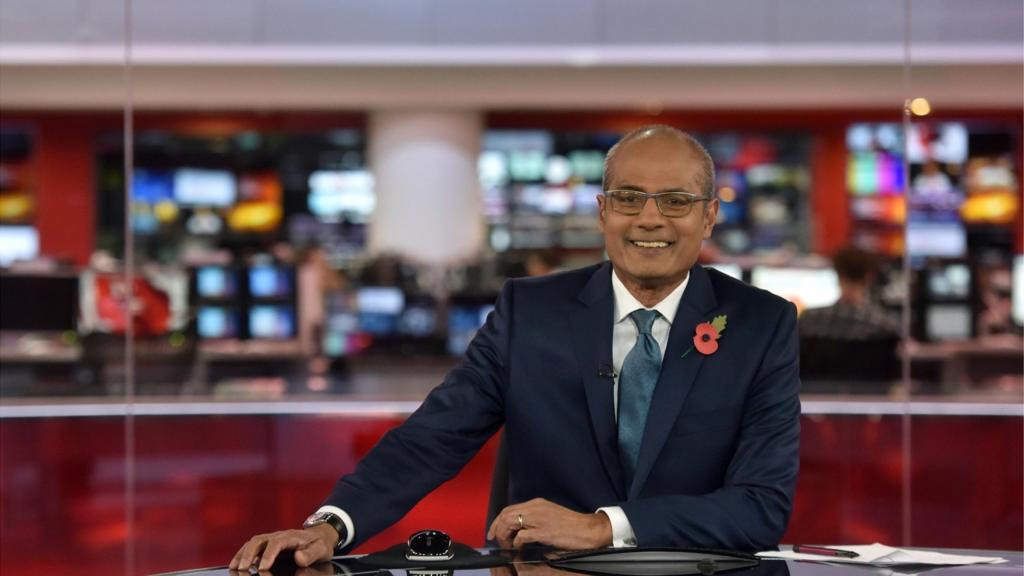 George Alagiah presenting in the BBC News studio