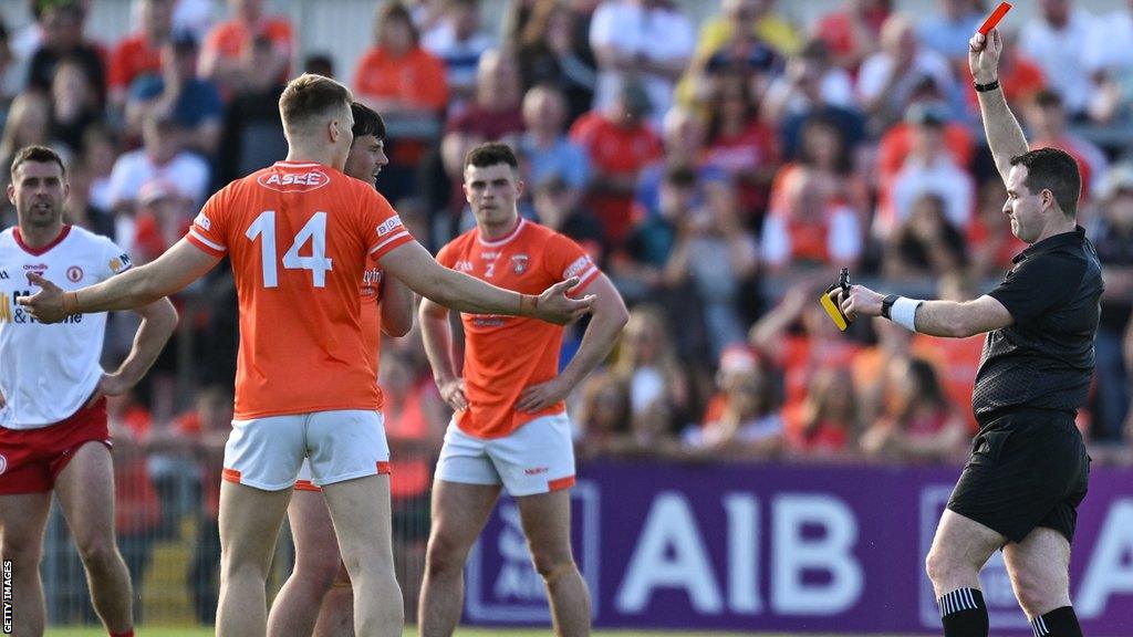 Rian O'Neill protests after being red carded by referee Martin McNally at Healy Park