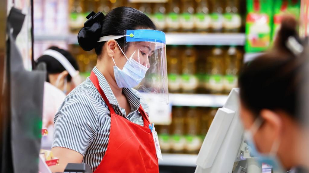 Supermarket worker in face mask