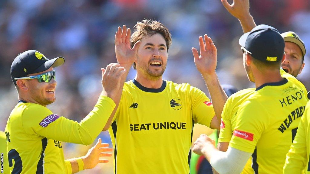 James Fuller (centre) celebrates a wicket for Hampshire