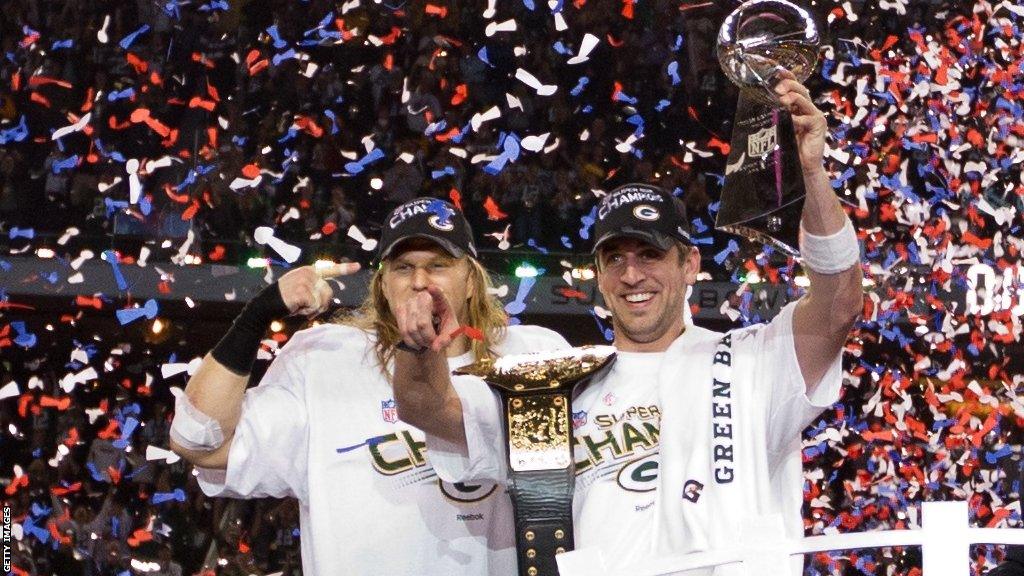 Aaron Rodgers lifts the Super Bowl trophy in 2011