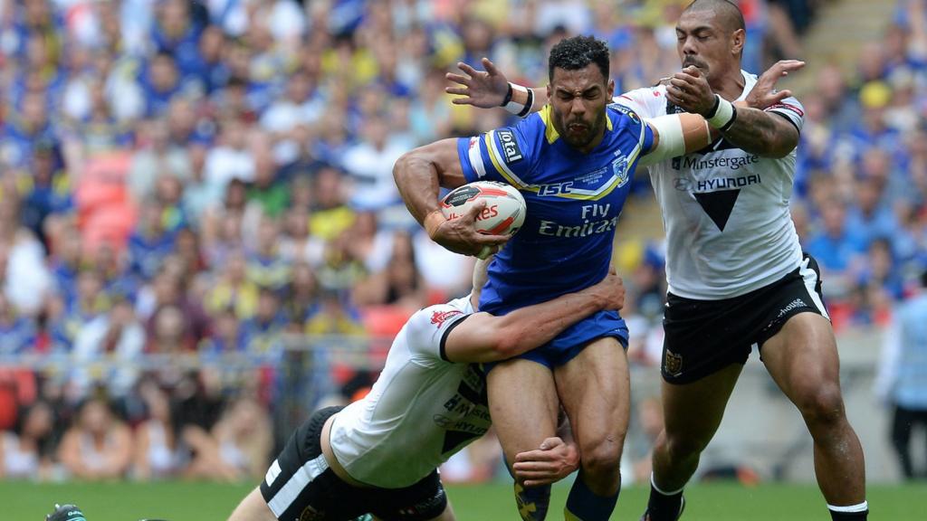 Warrington Wolves" Ryan Atkins is tackled by Hull FC"s Chris Green