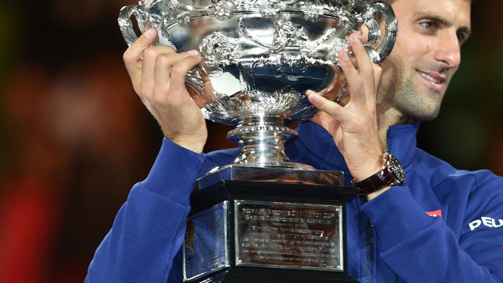 Novak Djokovic holds the Norman Brookes trophy