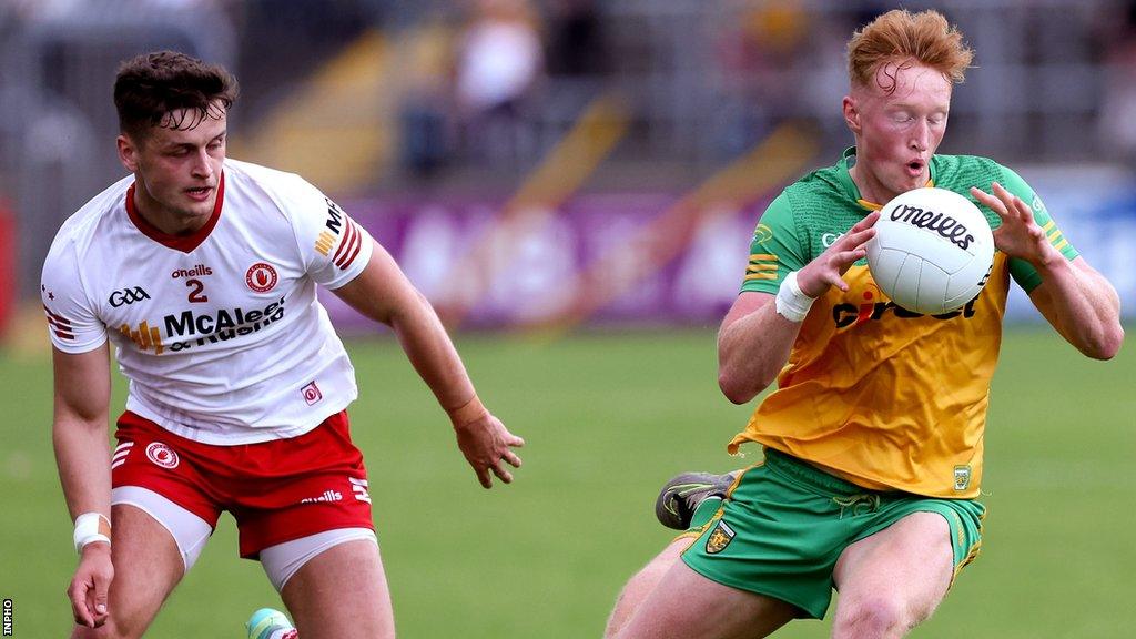 Tyrone defender Michael McKernan tries to keep pace with Donegal's Oisin Gallen