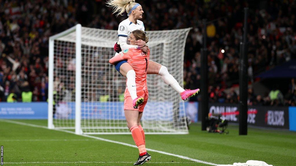 Chloe Kelly is embraced by England team-mate Mary Earps on the pitch at Wembley