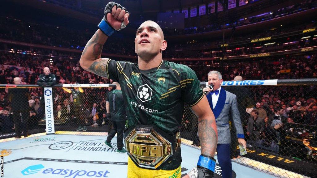 Alex Pereira celebrates with the UFC light-heavyweight title