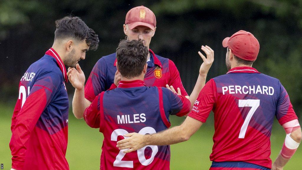 Jersey cricket team celebrate taking a wicket