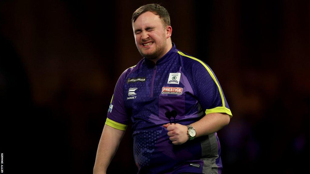 Luke Littler celebrates beating Rob Cross in the PDC World Darts Championship semi-final