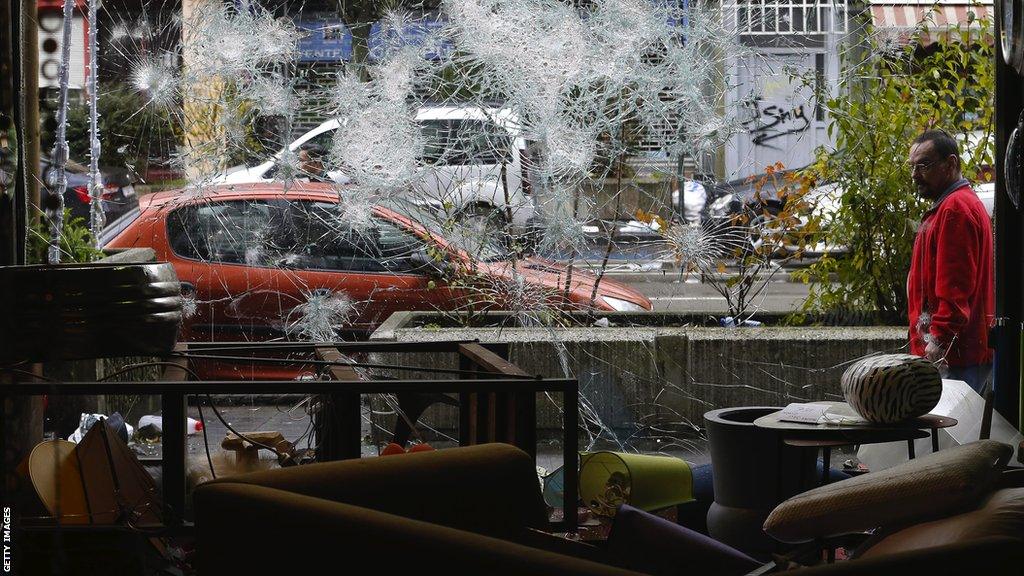 The smashed window of a business in Brussels after