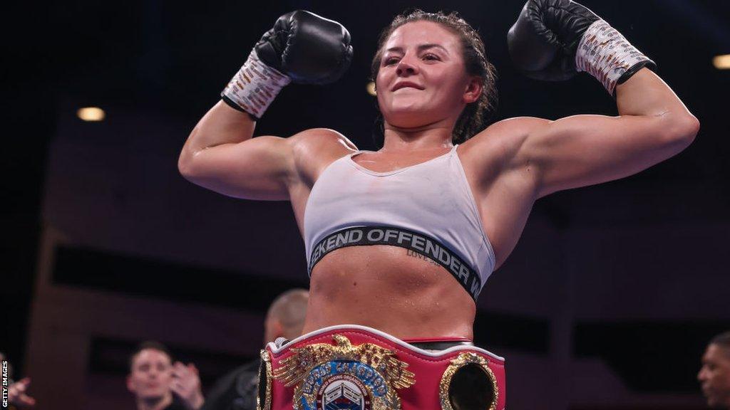 Sandy Ryan flexes her muscles with her world title around her waist