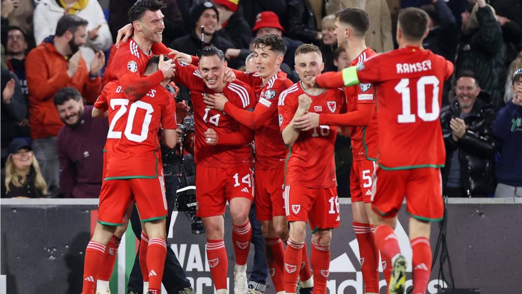 Kieffer Moore of Wales celebrates scoring a goal with team-mates
