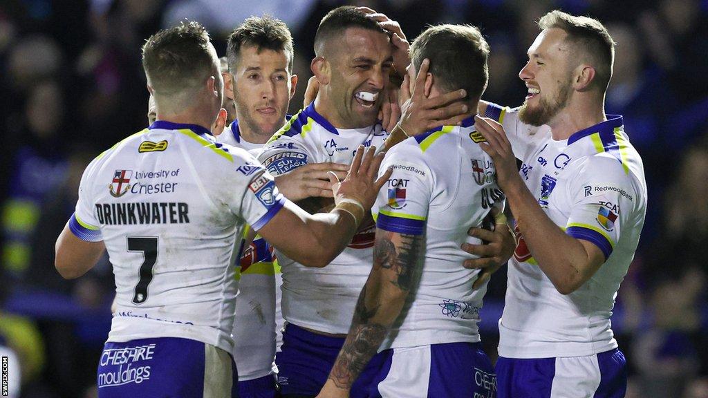 Paul Vaughan scores and celebrates with his Warrington teammates