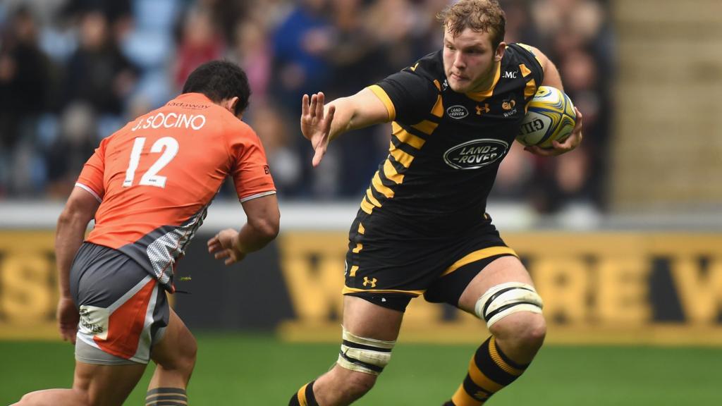 Joe Launchbury of Wasps holds off a tackle by Juan Pablo Socino