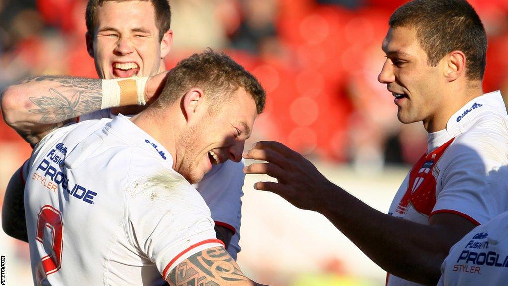 Ryan Hall and Zak Hardaker congratulate Josh Charnley for scoring a try while on England duty in 2012