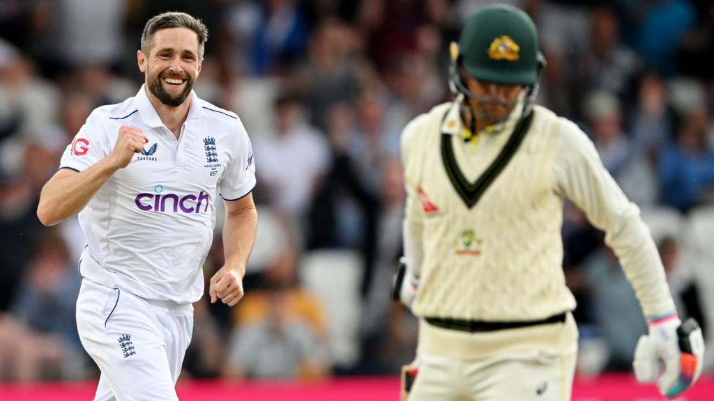 England bowler Chris Woakes (left) celebrates taking the wicket of Australia's Alex Carey (right)