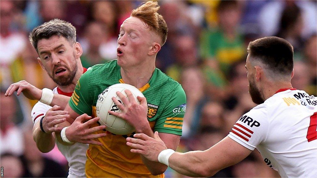 Tyrone's Mattie Donnelly and Padraig Hampsey challenge Donegal's Oisin Gallen