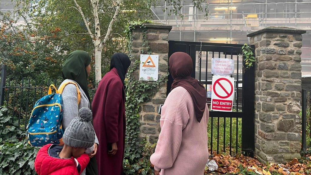 Four people looking at a wall