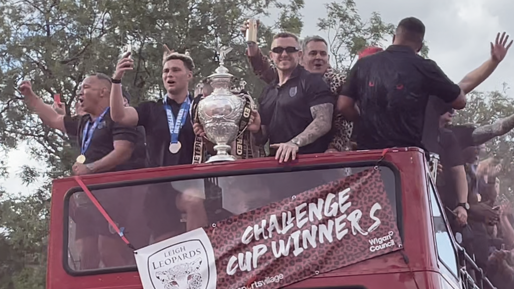 Leigh Leopards owner Derek Beaumont celebrated with the playing and coaching staff as the open top bus rolled into the town centre