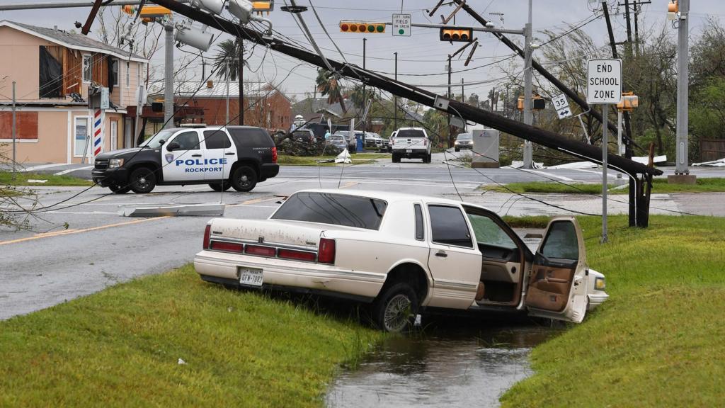 A car lies abandoned after heavy damage when Hurricane Harvey hit Rockport, Texas on August 26, 2017.