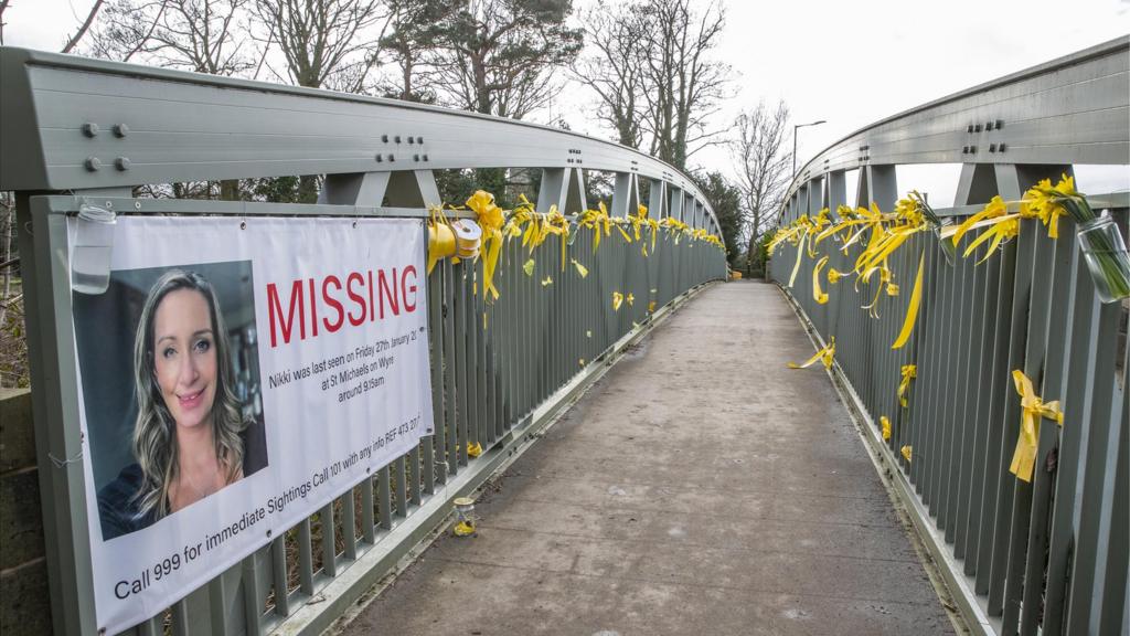 Bridge in St Michael's on Wyre with yellow ribbons and Nicola Bulley banner tied to it