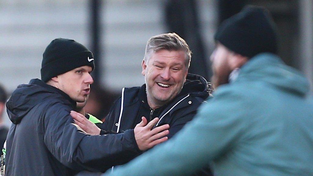 Salford City boss Karl Robinson talks to the fourth official after his sending off against Forest Green Rovers