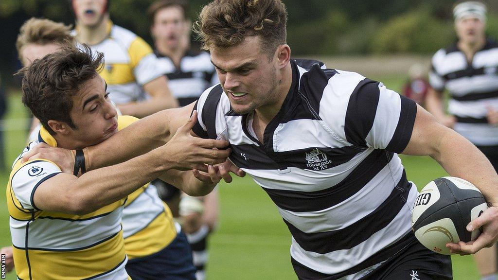 Ben Earl hands off an opponent while playing for Tonbridge School