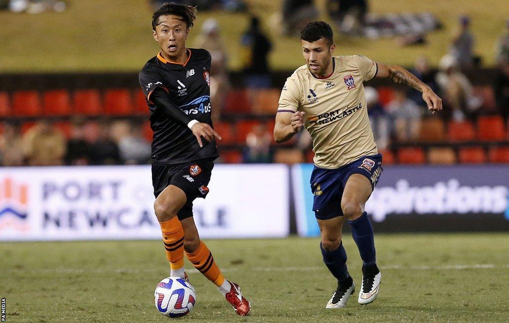 Riku Danzaki (left) in action for Brisbane Roar