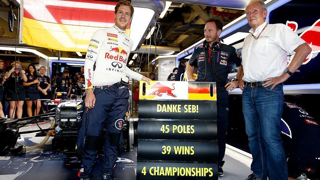 Sebastian Vettel, Christian Horner and Helmut Marko stand in the Red Bull garage with a sign that reads: "Danke Seb! 45 poles, 39 wins, 4 championships"