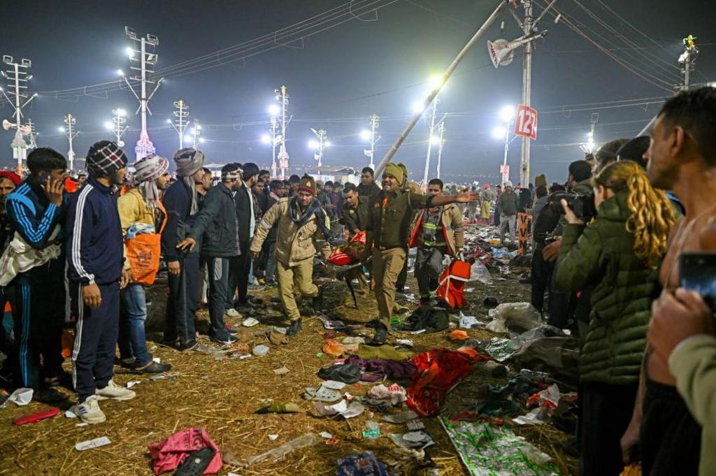 Police personnel carry victims of stampede amid the ongoing Maha Kumbh Mela festival in Prayagraj on January 29, 2025