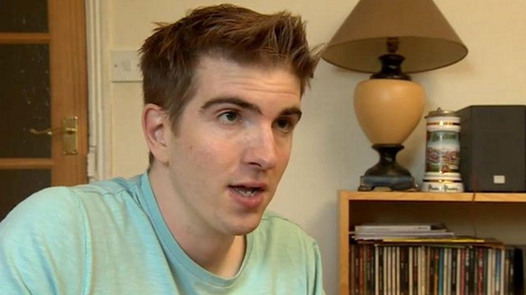 A man sat inside a home giving an interview