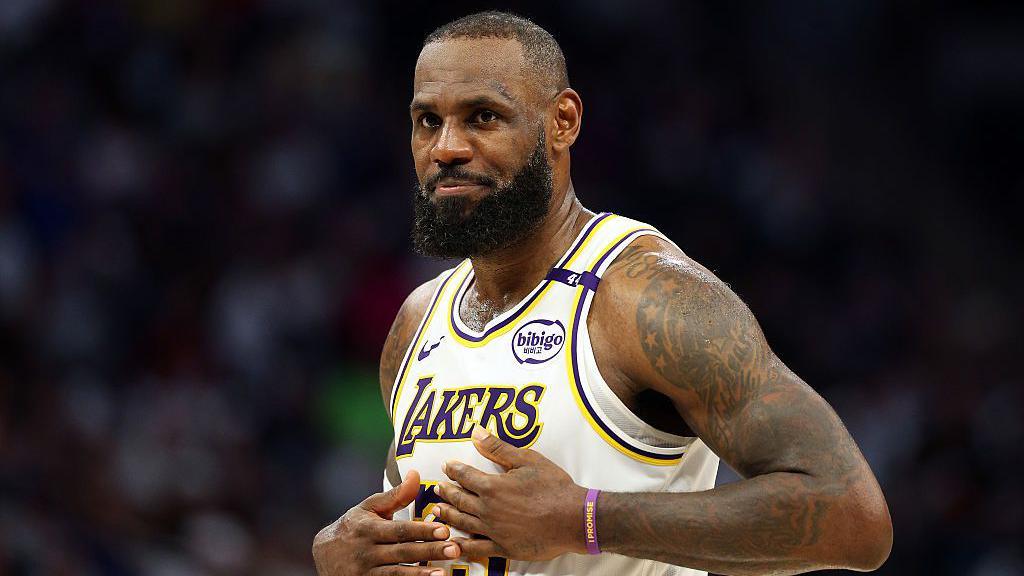 LeBron James holds his hands on his chest