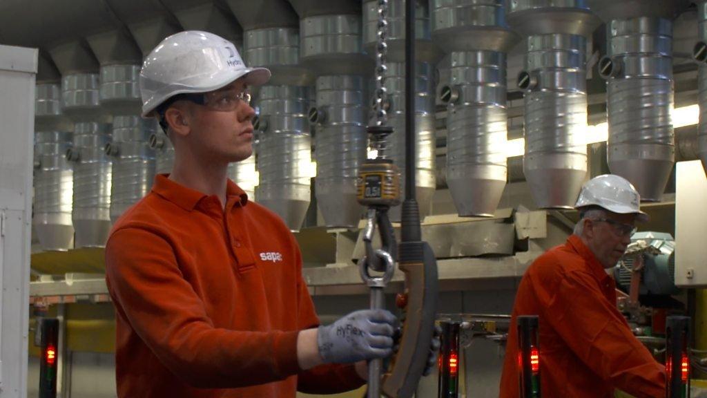 Aluminium factory worker on production line.