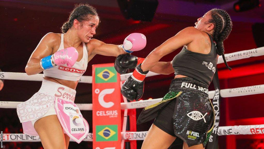 Amanda Serrano (left) throws a punch at Danila Ramos (right)