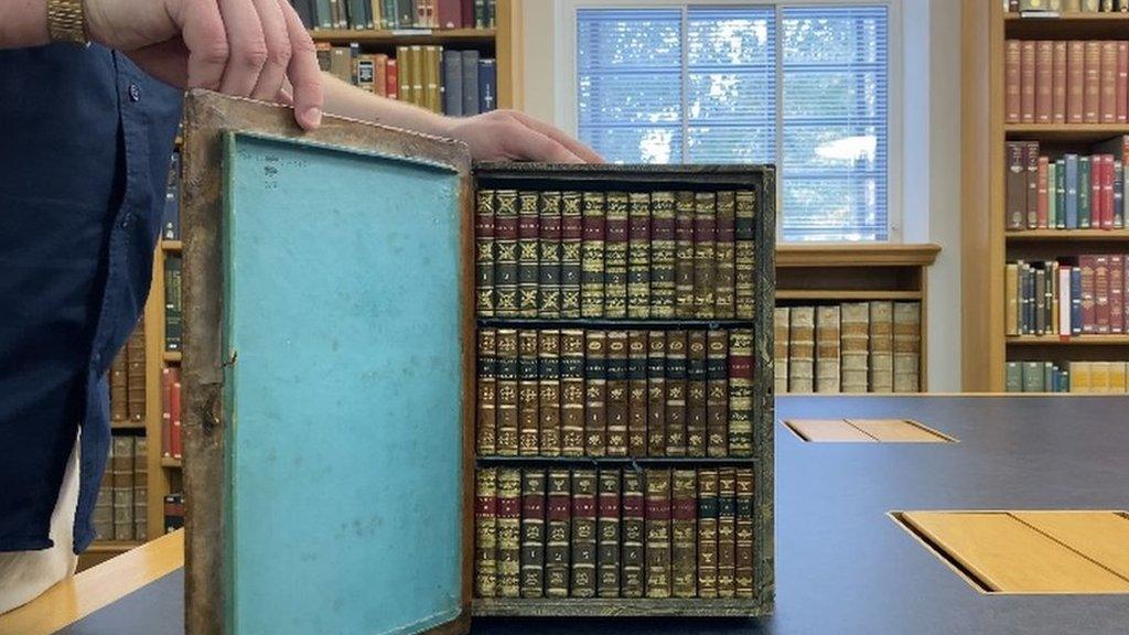 Travelling library opened up to show the small books inside