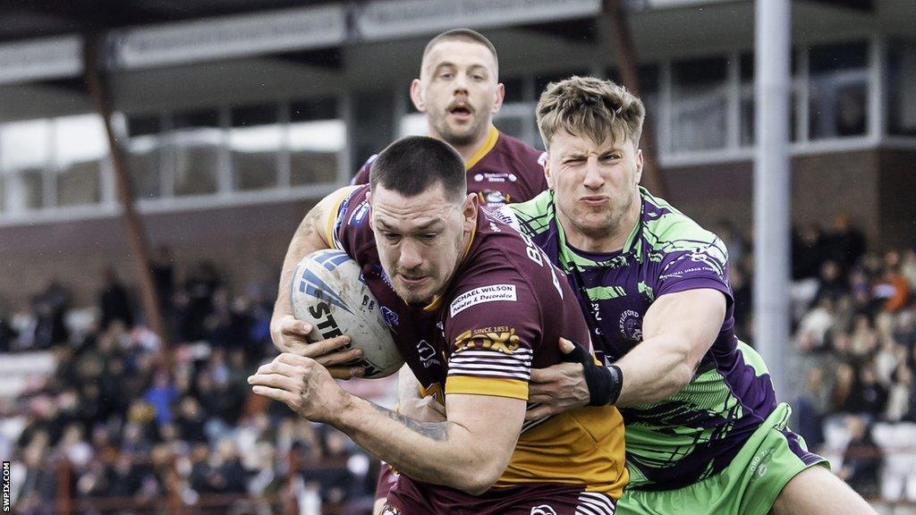 Batley's Kieran Buchanan is tackled by Castleford's Alex Mellor