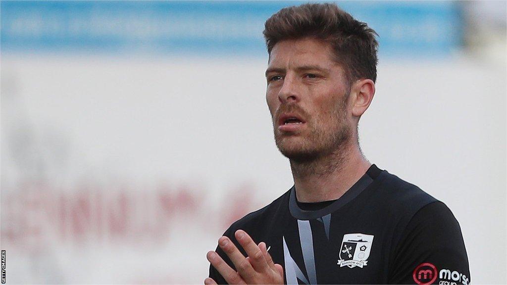 Jamie Proctor applauds fans at a Barrow game